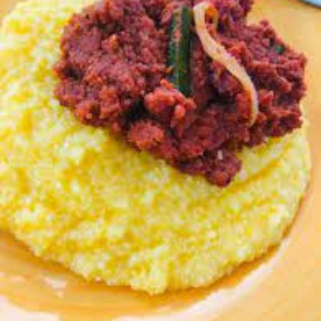 "Bahamian corned beef and yellow grits on a mustard plate"