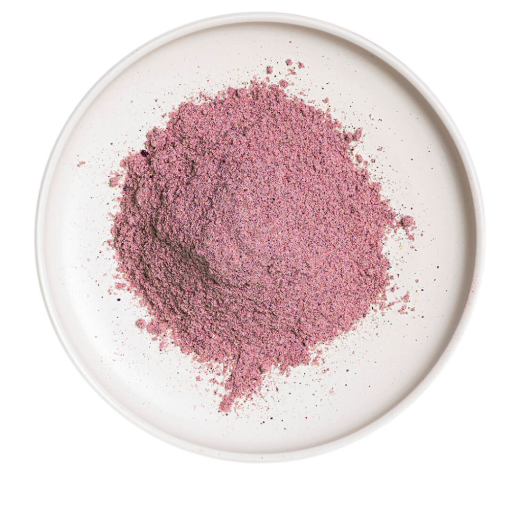 "Berry protein powder on whit plate"