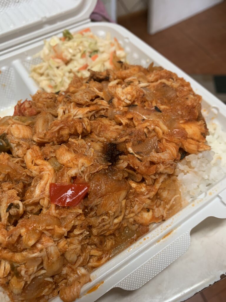 "Bahamian Steamed Crawfish Dinner with coleslaw in a white tray"