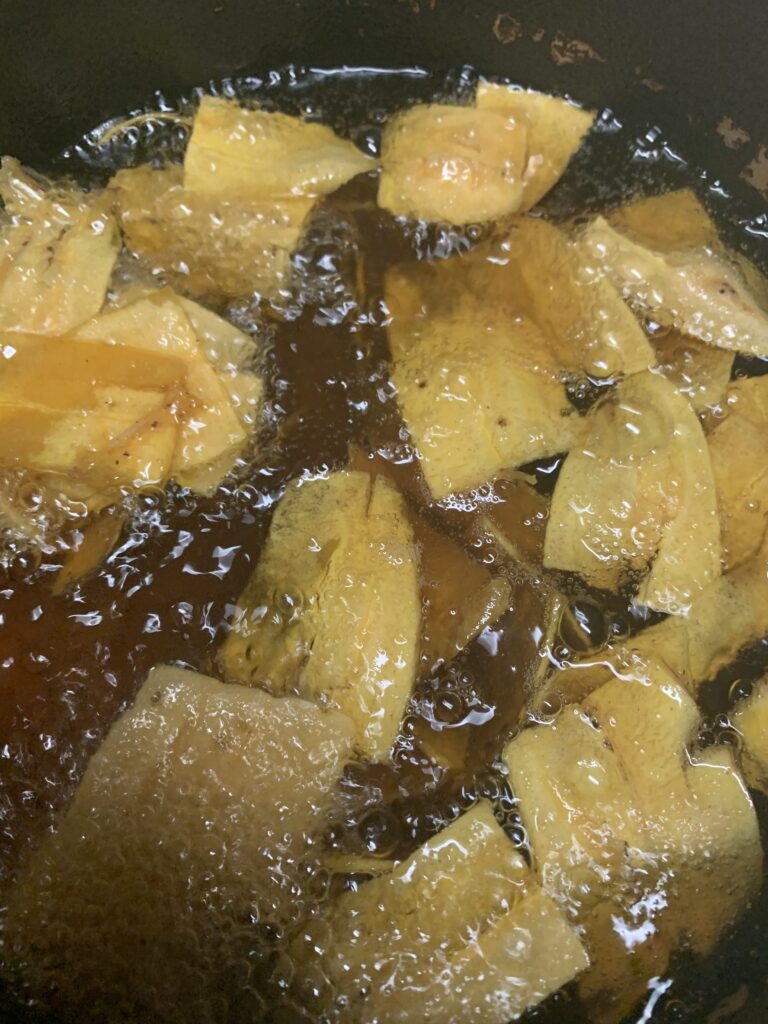 "Green plantain chips frying in hot oil
