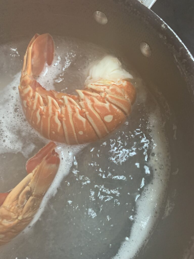 "Bright red crawfish tails in a pot of boiling water"