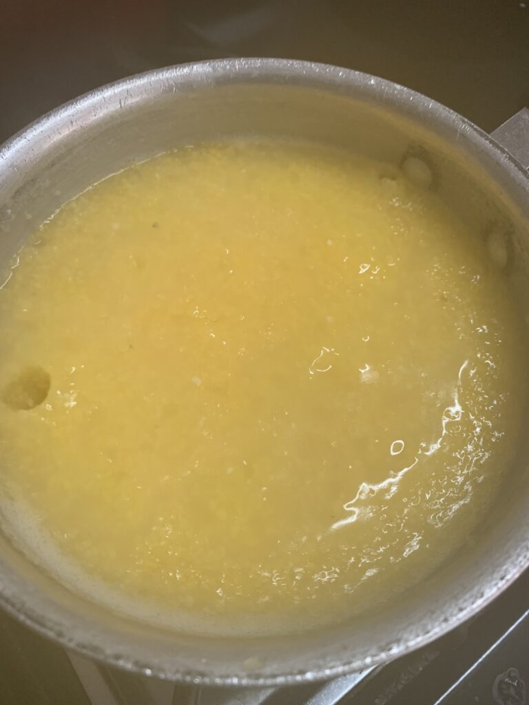 "Yellow grits in a sauce pot"