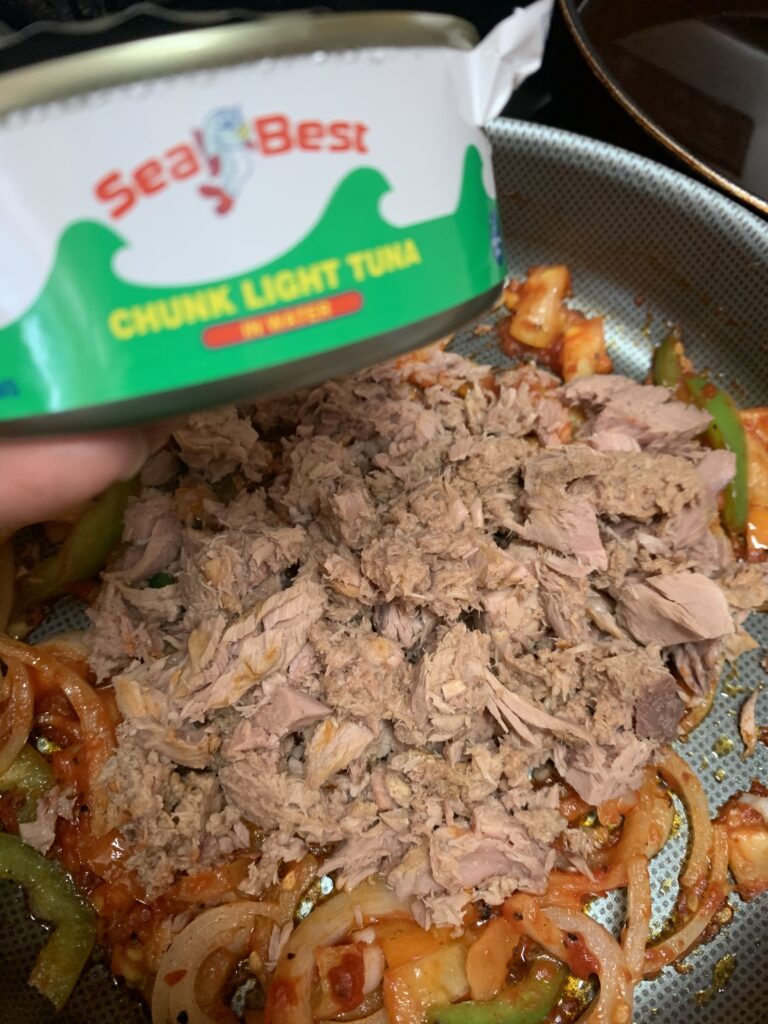 "Canned tuna, with sauteed vegetables with a can of tuna in a picture"