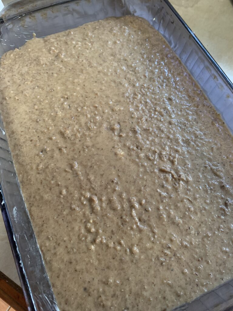 "Bread mixture in a baking pan on kitchen counter top