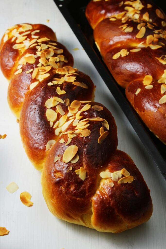 "greek braided sweet bread on white table top, bread top with nuts