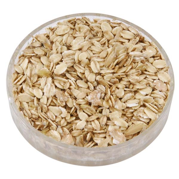 "A bowl of rolled oats on a white background"