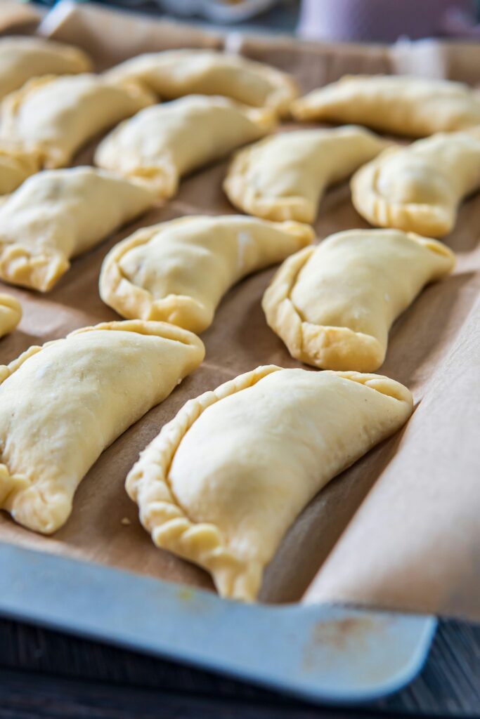 "turnovers on a line baking tray ready for the oven"