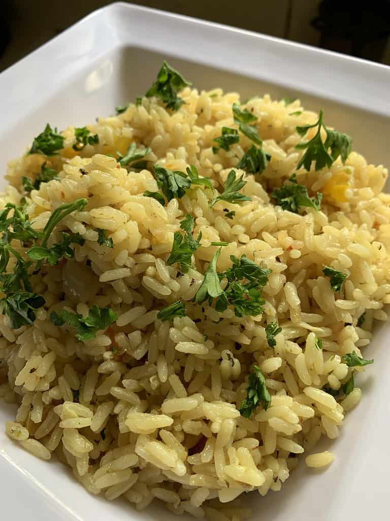 Rice in a white bowl topped with Parsley