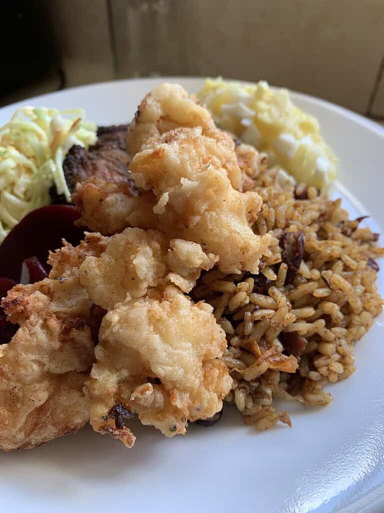 Fried conch with peas and rice, coleslaw and potato salad