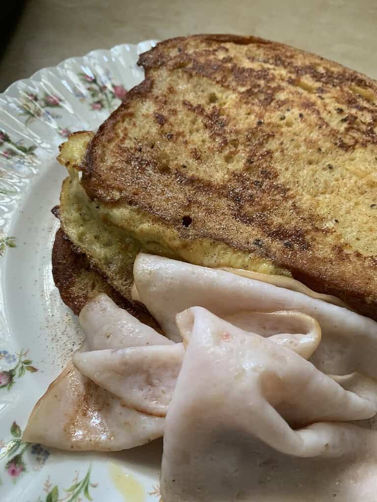 Fresh toast with ham slice on a colorful plate