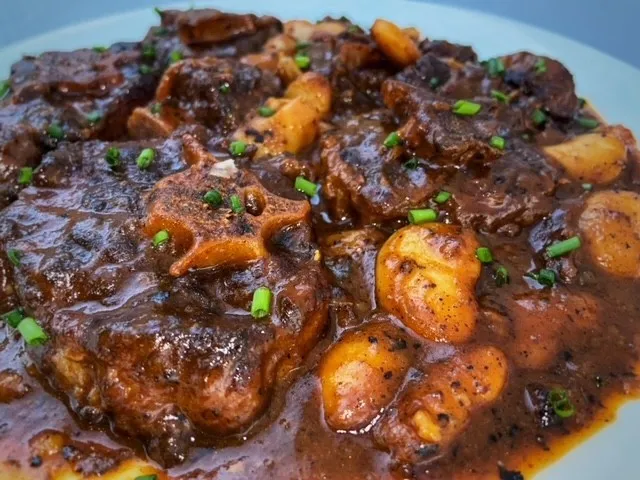 Oxtail meat in a stew gravy with beans