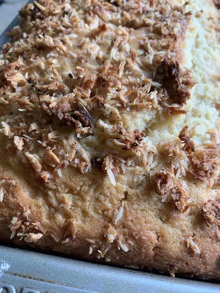 Ginger lime cake in a loaf pan with slices cut from cake