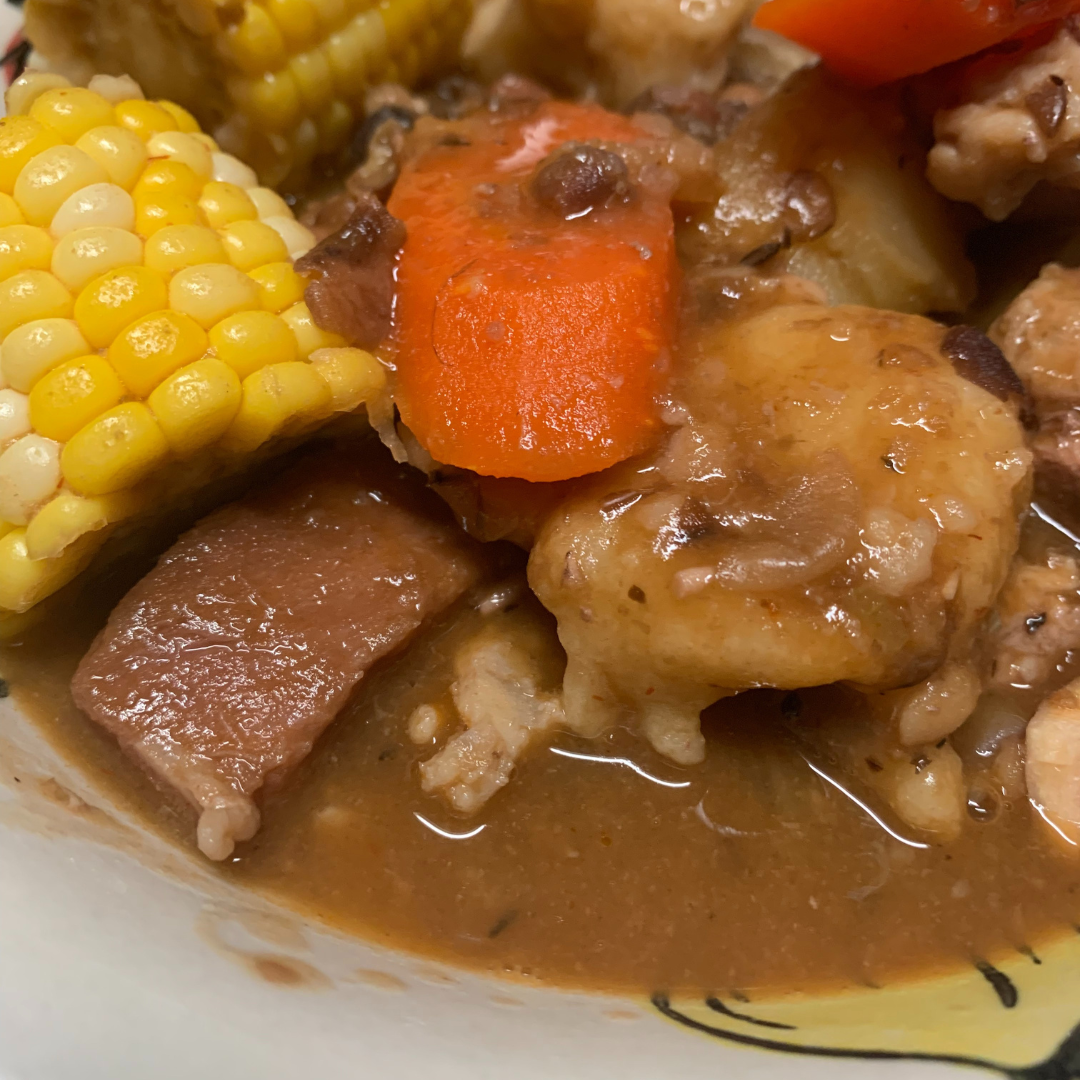 "Bahamian peas soup recipe with corn, carrots and meat in a bowl"