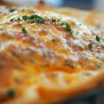 "a egg custard stop with cheese baked until golden brown"